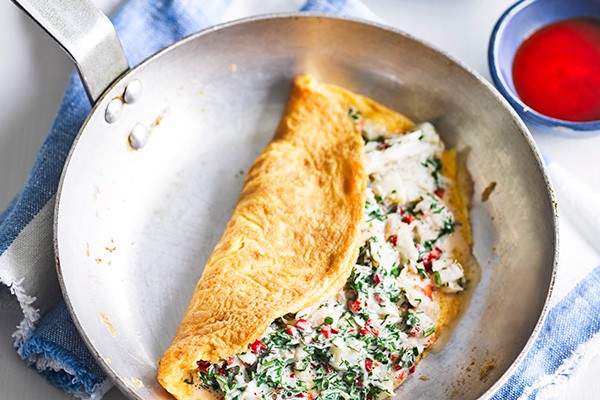 Seafood Omelette Recipe with Chilli Seafood Omelette Recipe with Chilli served in a silver pan with a side of chilli sauce