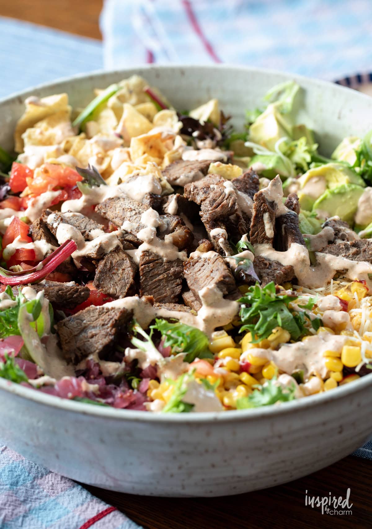steak taco salad in large white bowl.