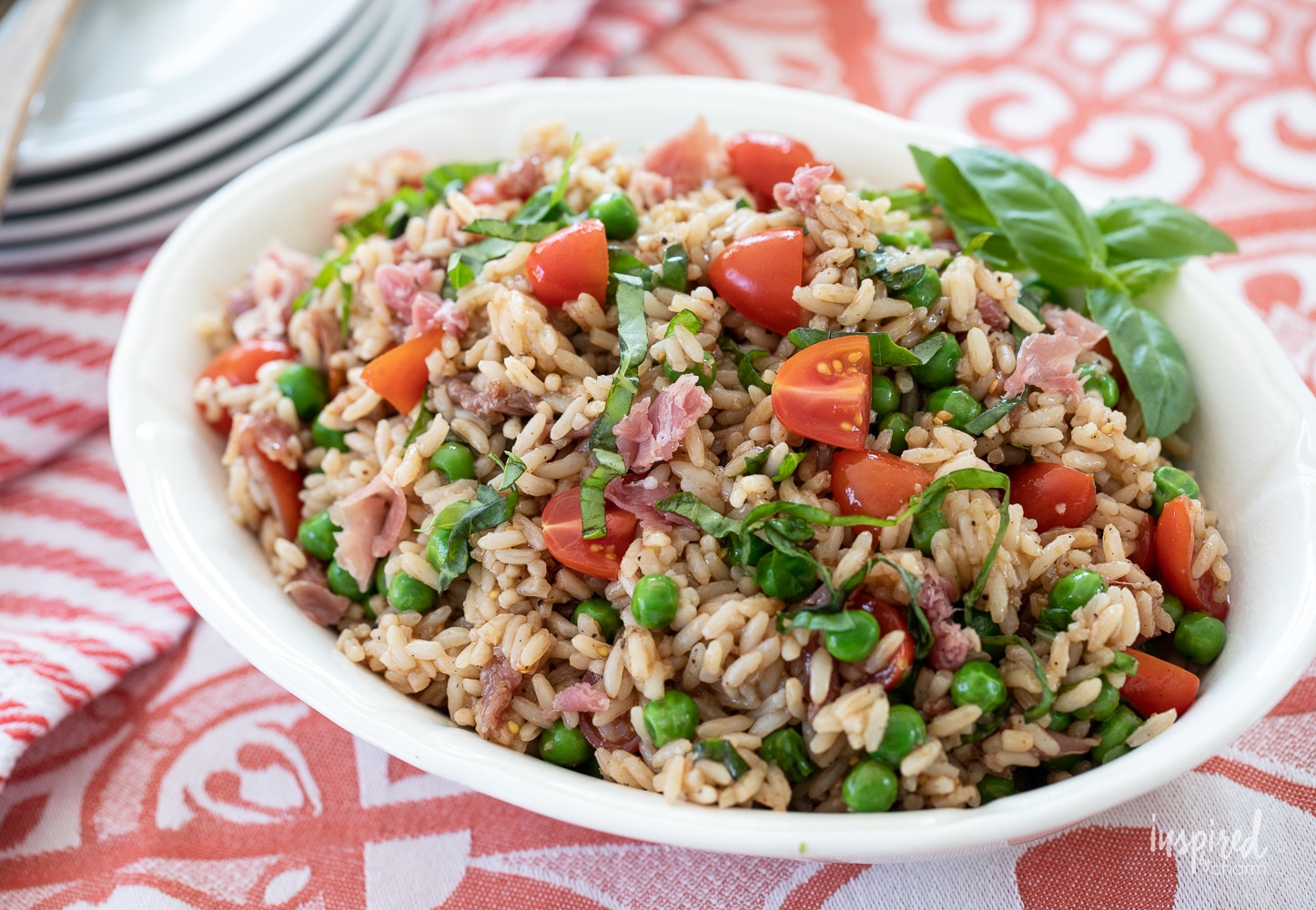 Italian rice salad in a white oval bowl.