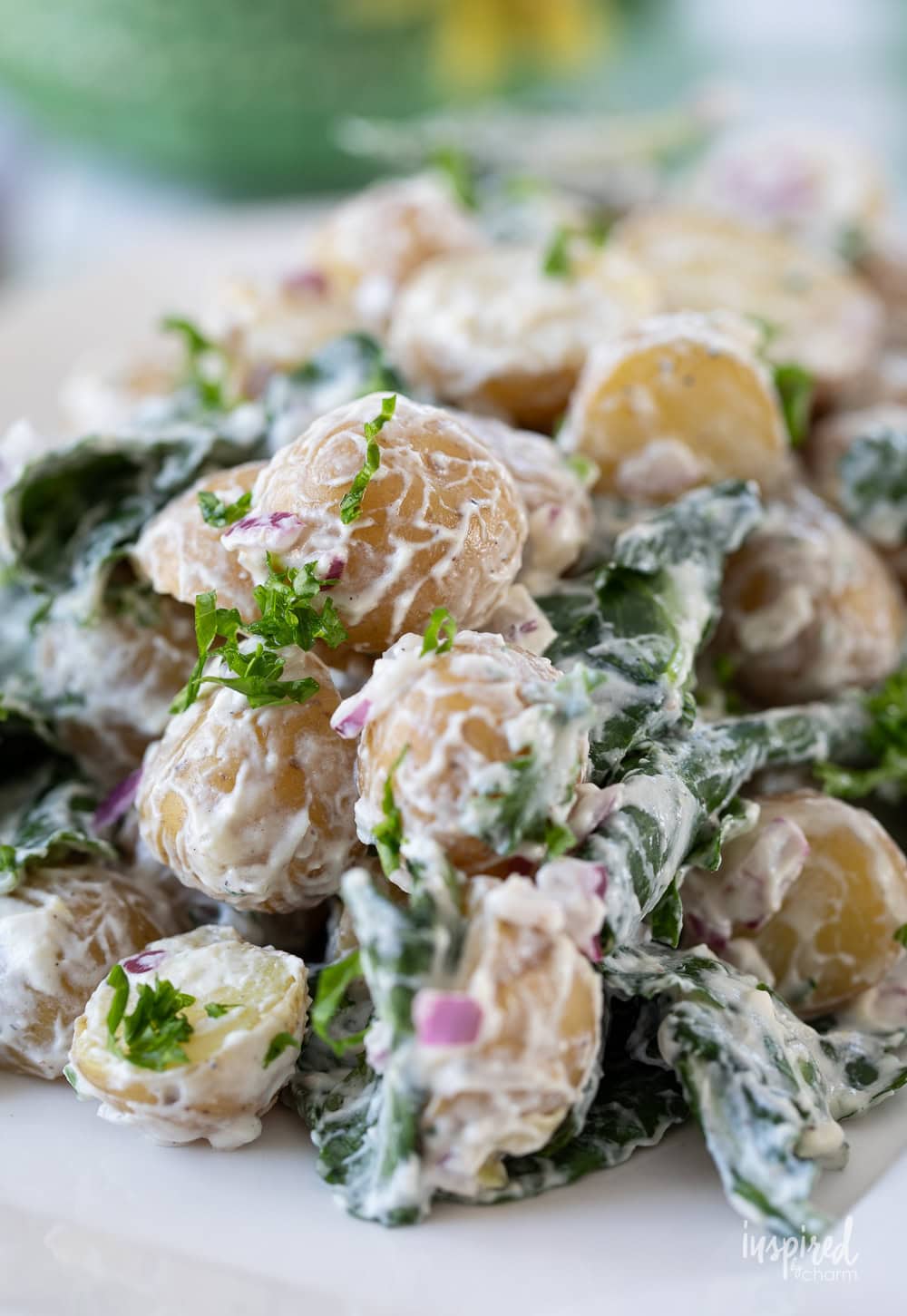 kale and potato salad served on a large white platter.