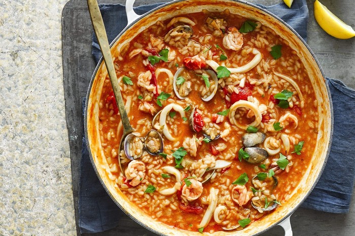 Perfect risotto Seafood risotto in a bowl with spoon